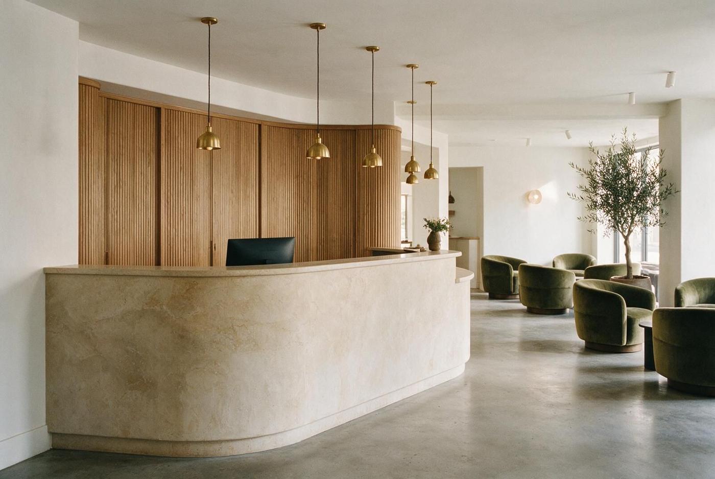 Placeholder image: a boutique reception lounge with oak panels and velvet chairs